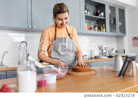 woman cooking food and baking on kitchen at home 82923219