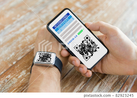 hands with virtual immunity passport on smartphone 82923245