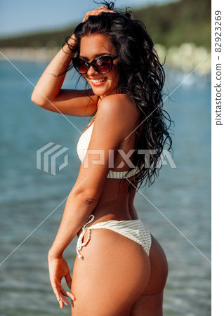 smiling young woman in bikini swimsuit on beach smiling young woman in bikini swimsuit on beach 82923269