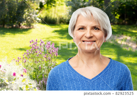 portrait of smiling senior woman in blue sweater 82923525