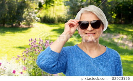 smiling senior woman in black sunglasses smiling senior woman in black sunglasses 82923536