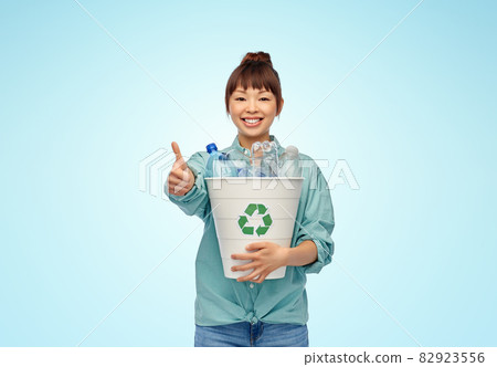 smiling young asian woman sorting plastic waste smiling young asian woman sorting plastic waste 82923556