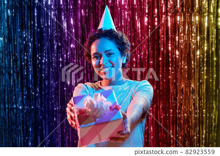african woman in birthday party cap with gift box african woman in birthday party cap with gift box 82923559