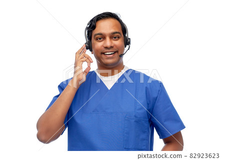 smiling indian doctor or male nurse with headset smiling indian doctor or male nurse with headset 82923623