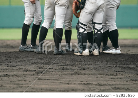 Infielders such as pitchers and catchers gathering on the mound during a baseball game Infielders such as pitchers and catchers gathering on the mound during a baseball game 82923650