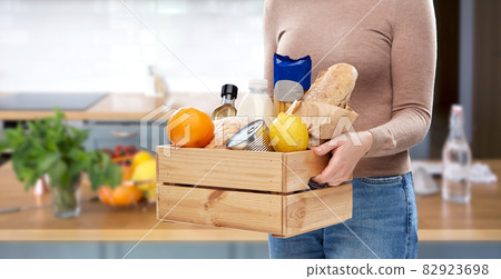 close up of woman with food in wooden box 82923698