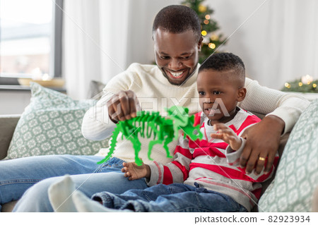 happy father playing with son on christmas at home happy father playing with son on christmas at home 82923934