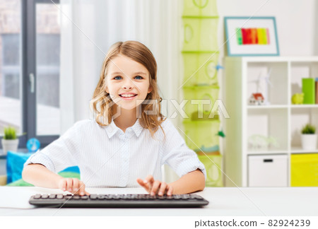 happy student girl with keyboard at home happy student girl with keyboard at home 82924239