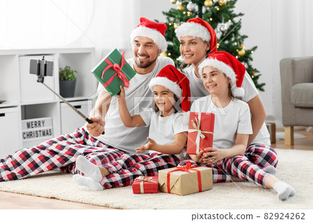 happy family taking selfie on christmas at home 82924262