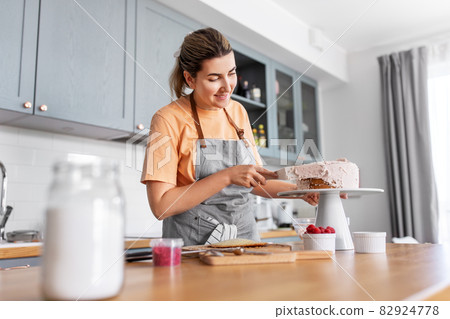 woman cooking food and baking on kitchen at home woman cooking food and baking on kitchen at home 82924778
