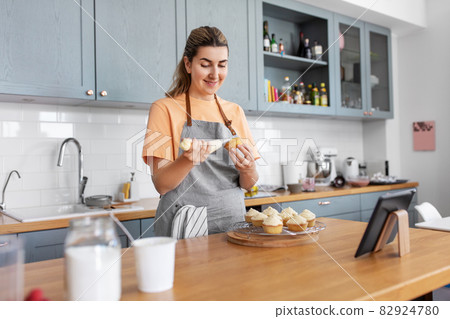 woman cooking food and baking on kitchen at home woman cooking food and baking on kitchen at home 82924780
