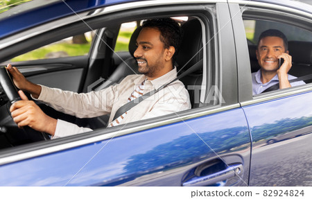 male passenger calling on smartphone in taxi car 82924824