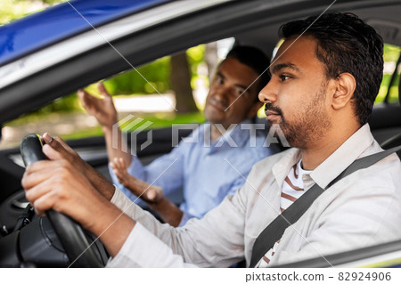 car driving instructor talking to man failed exam 82924906