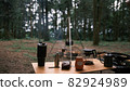 Coffee drip while camping in the forest. Coffee maker outdoor, campsite morning picnic lifestyle, person cooking hot drink in nature camping, cooker prepare breakfast. Sunrise and chill time in camp 82924989