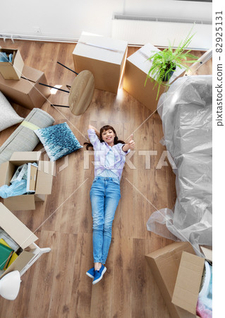 happy woman with boxes moving to new home happy woman with boxes moving to new home 82925131