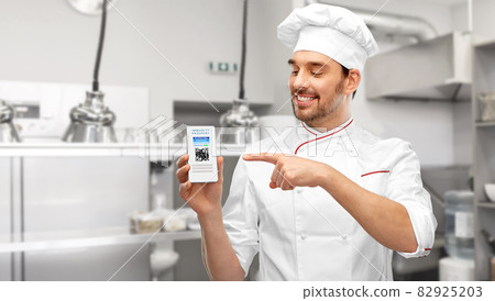 chef with virtual immunity passport on smartphone 82925203