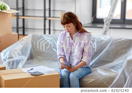 asian woman moving to new home and counting money asian woman moving to new home and counting money 82925240