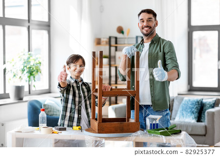 father and son sanding old table with sponge father and son sanding old table with sponge 82925377