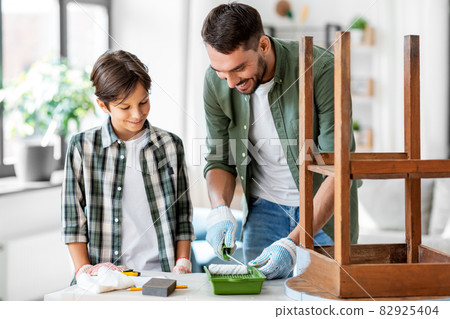 father and son painting old table at home father and son painting old table at home 82925404