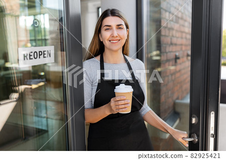 happy woman with coffee and reopen banner on door 82925421