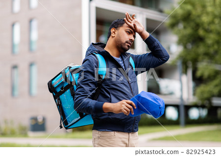 tired indian delivery man with bag in city tired indian delivery man with bag in city 82925423