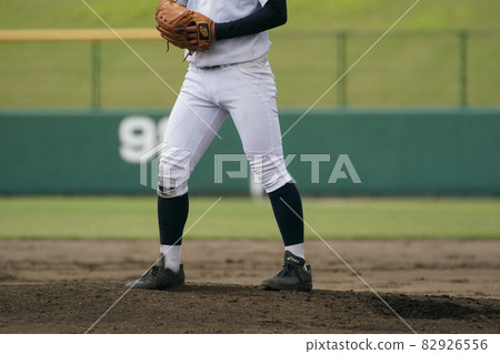 A pitcher throwing a white ball from the mound during a baseball game A pitcher throwing a white ball from the mound during a baseball game 82926556