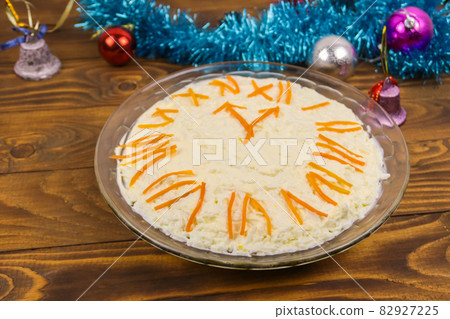New Year's holiday salad "Clock" on a wooden table New Year's holiday salad "Clock" on a wooden table 82927225