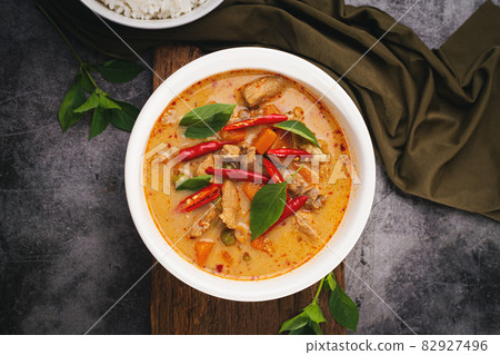 Panang Curry with Pork served with rice on a dark background. Panang Curry with Pork served with rice on a dark background. 82927496