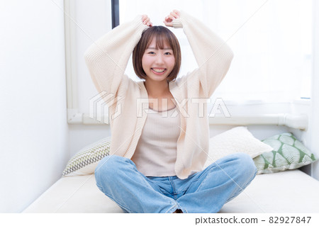 A woman smiling happily in bed 82927847