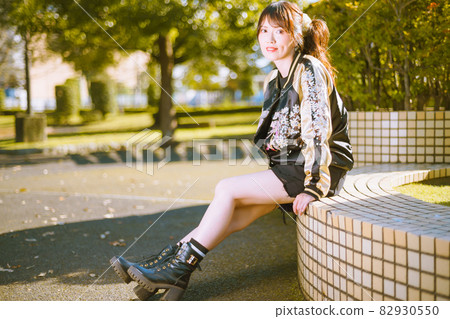 Cute girl taking a walk in the autumn park Cute girl taking a walk in the autumn park 82930550
