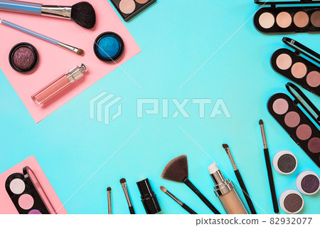Various cosmetics and brushes on blue background 82932077