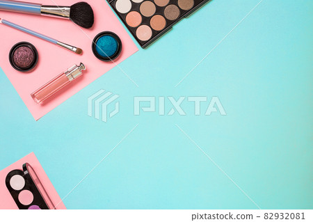 Make up essentials. Set of professional make up brushes, creams and shadows in jars on blue background. Make up essentials. Set of professional make up brushes, creams and shadows in jars on blue background. 82932081
