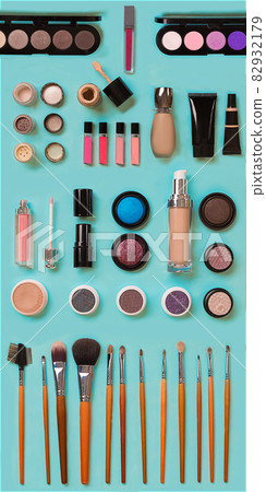 cosmetics for facial makeup: brushes, powder, lipstick, eye shadow, trimmer and other accessories on blue background top view. cosmetics for facial makeup: brushes, powder, lipstick, eye shadow, trimmer and other accessories on blue background top view. 82932179