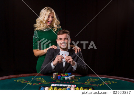 Poker player showing a pair of aces 82933887