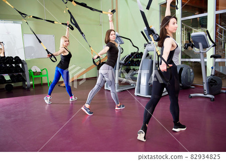 Group of sportive people training in a gym. Group of sportive people training in a gym. 82934825