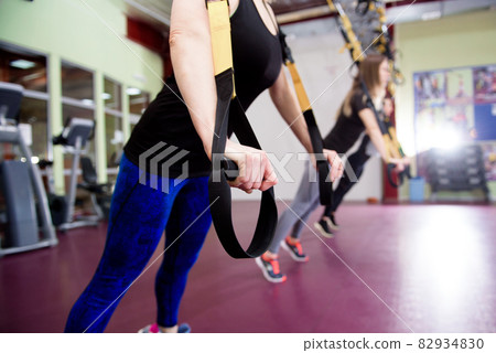 Group of sportive people training in a gym. Group of sportive people training in a gym. 82934830