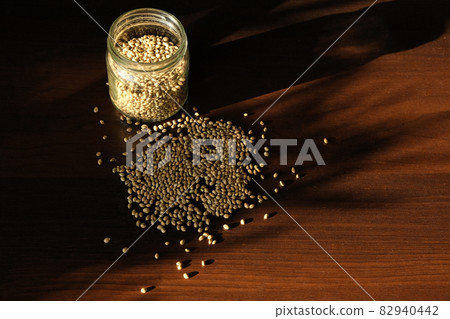Marijuana seed's storage. Cannabis seeds on brown wooden background. 82940442