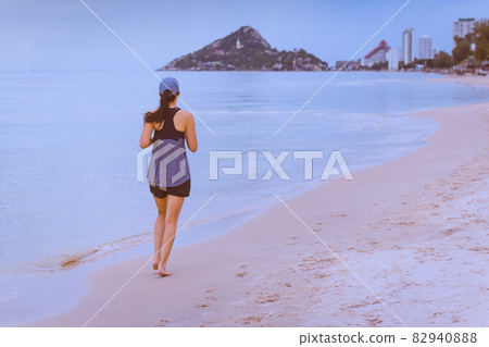 Full length body of woman jogging on the beach doing workout summer vacation. Full length body of woman jogging on the beach doing workout summer vacation. 82940888