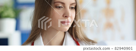 Young female doctor examines medical history of patient 82940901