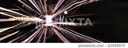 Closeup of bright sparks from laser cutting of metal Closeup of bright sparks from laser cutting of metal 82940974