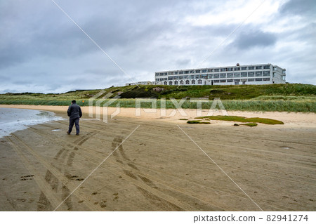 Man walking at Bunbeg beach , Bunbeg, Co. Donegal, Ireland Man walking at Bunbeg beach , Bunbeg, Co. Donegal, Ireland 82941274