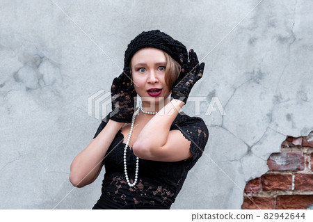 beautiful woman in retro style on a brick wall background 82942644