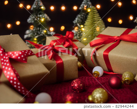 Gift boxes and christmas balls against bokeh lights background 82944244