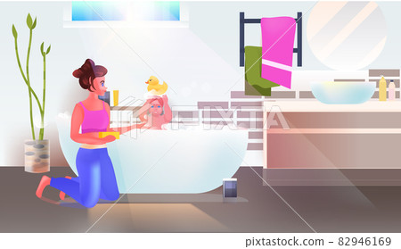 young woman washing little daughter in bath bathroom interior horizontal full length young woman washing little daughter in bath bathroom interior horizontal full length 82946169