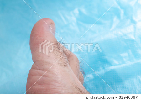 Toe hair on a blue background, copy space for text. Hair removal from toes, hygienic Toe hair on a blue background, copy space for text. Hair removal from toes, hygienic 82946387