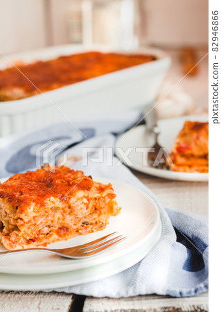 Piece of tasty hot lasagna served with on a white plate. Italian cuisine, menu, recipe. Homemade meat lasagna 82946866