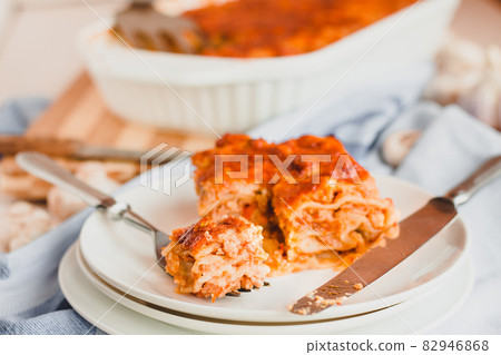 Piece of tasty hot lasagna served with on a white plate. Italian cuisine, menu, recipe. Homemade meat lasagna 82946868