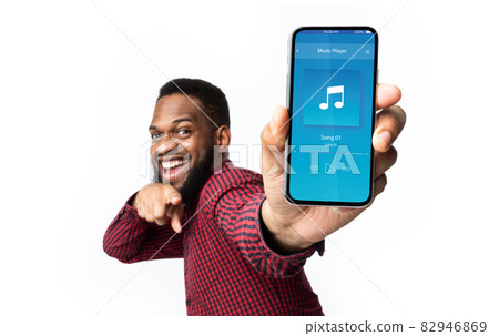 Audio Player App. Black Man Pointing At Smartphone With Opened Music Application 82946869