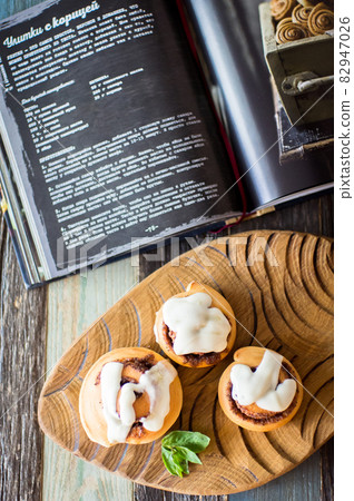 Homemade cinnamon buns and recipe book. High quality photo Homemade cinnamon buns and recipe book. High quality photo 82947026