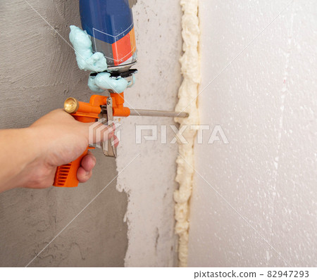 Construction foam gun with a defective cylinder. Foam bottle defect, close-up 82947293